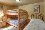 Big  Bear Lodge bedroom with a twin and bunk beds.